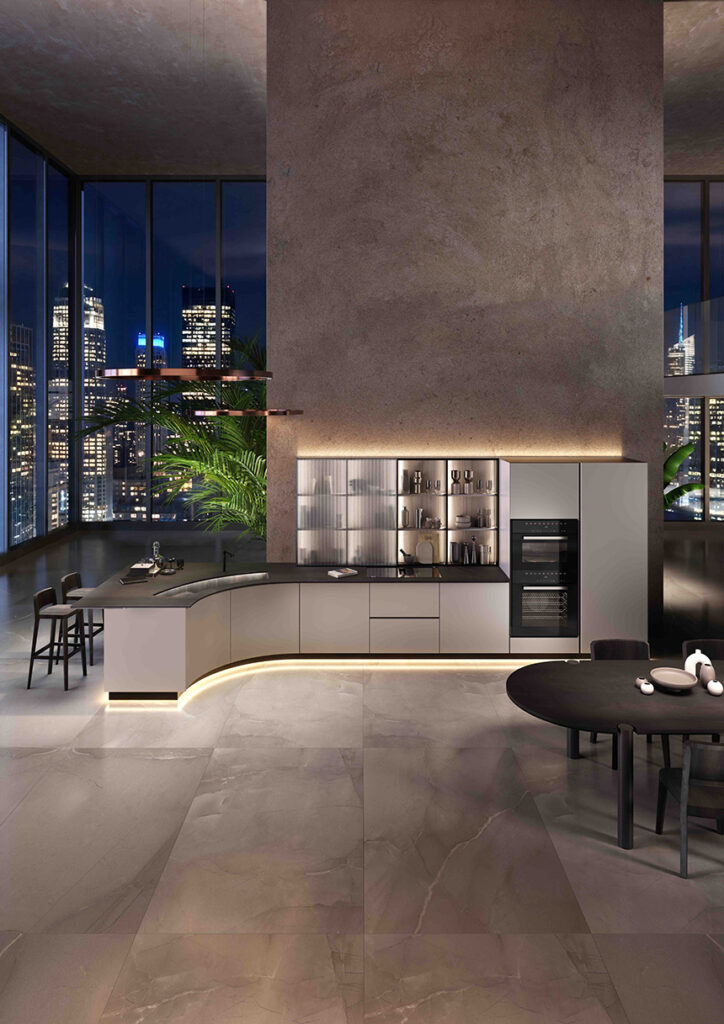 Cocina de diseño italiano con isla curva y superficies continuas